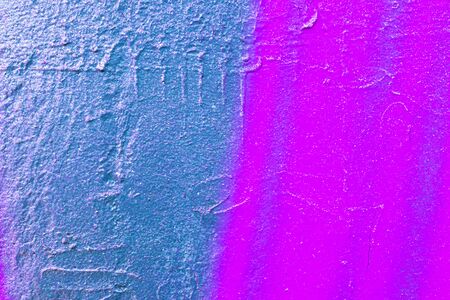 Fragment of colorful graffiti painted on a concrete wall. Bright purple abstract background for...
