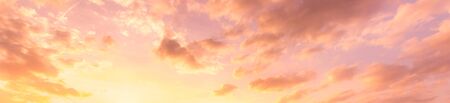 Cloudy sky at sunset or sunrise with sunlight. Abstract backdrop for design.