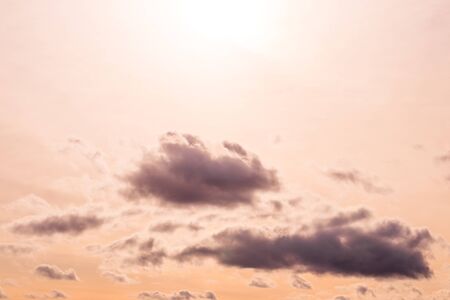 Cloudy sky at sunset or sunrise with sunlight. Abstract background for design.