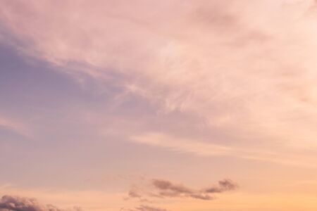 Cloudy sky at sunset or sunrise with sunlight. Abstract background for design.