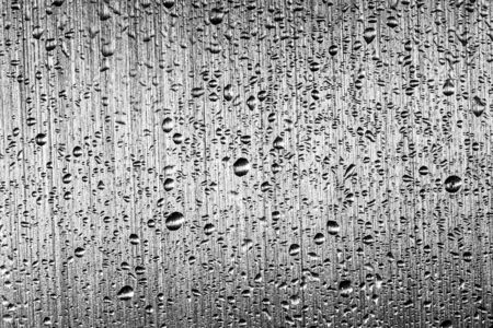 Macro water drops texture on a gray metal background. Abstract pattern or blank for design.の写真素材