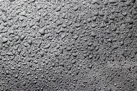 Macro water drops texture on a black background. Abstract pattern or blank for design.の写真素材