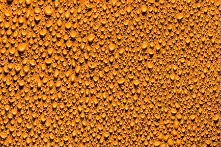 Macro water drops texture on a orange background. Abstract pattern or blank for design.の写真素材