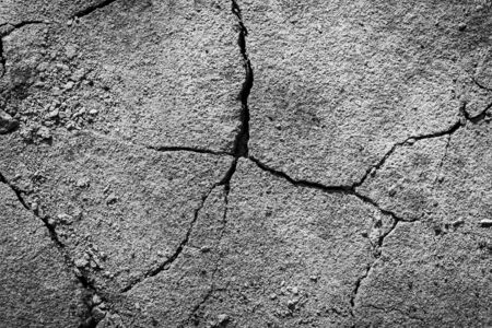 Black and white texture of a concrete wall with a crack. Abstract background for design. Monochrome.の写真素材