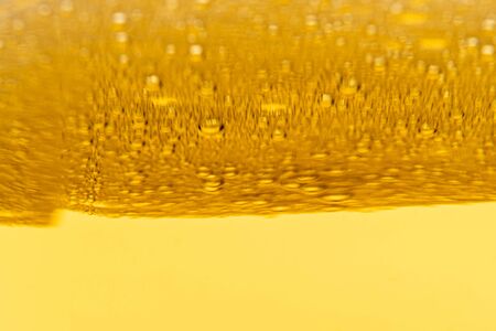 Texture of foam and gas bubbles in light beer. Abstract background for design.の写真素材