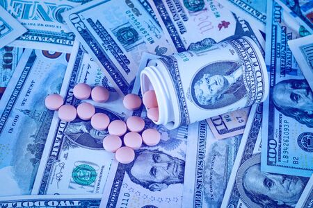 Medicine pills or capsules with dollars. Pharmacy prescription for health. Concept of cost of the healthy life.の写真素材