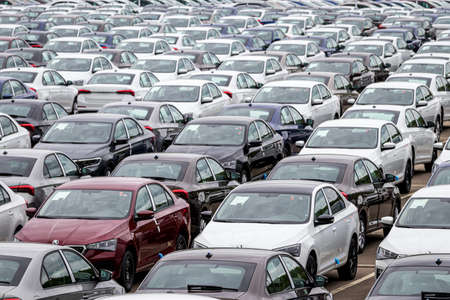 Volkswagen Group Rus, Russia, Kaluga  - MAY 24, 2020: Rows of a new cars parked in a distribution center on a cloudy day in the spring, a car factory. Top view to the parking in the open air.のeditorial素材