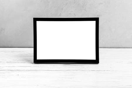 White wooden floor over concrete or decorative plaster wall and black photo frame with copy space for a text background. Mock up for design.の写真素材