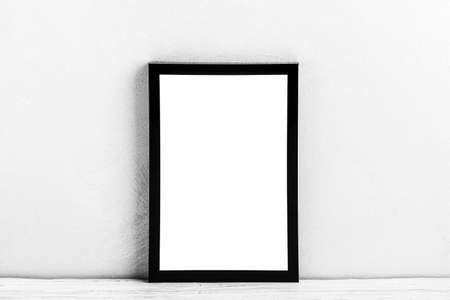 White wooden floor over concrete or decorative plaster wall and black photo frame with copy space for a text background. Mock up for design.の写真素材