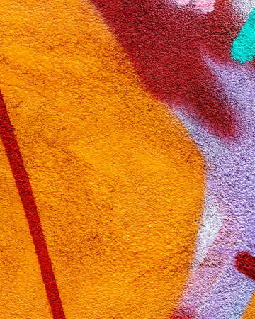 Fragment of colored graffiti painted on a concrete wall. Texture. Abstract background for design.
