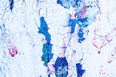 Fragment of colorful graffiti painted on a wall. Bright abstract background for design with peeling...