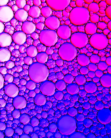 Top view on colorful drops of oil on the water. Circles and ovals.