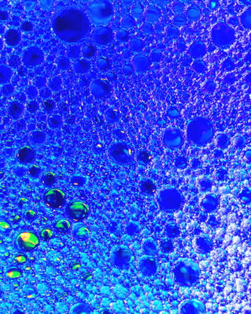 Top view on colorful drops of oil on the water. Circles and ovals.