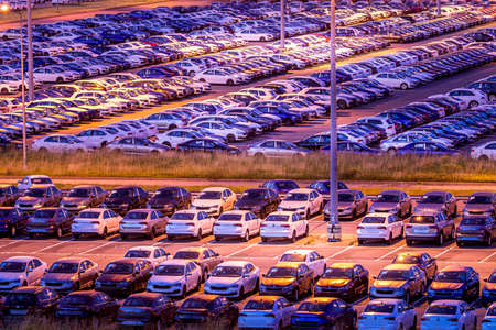 Volkswagen, Russia, Kaluga - AUGUST 26, 2020: New cars parked at distribution center of automobile factory at night with lights. Parking on the open air.のeditorial素材