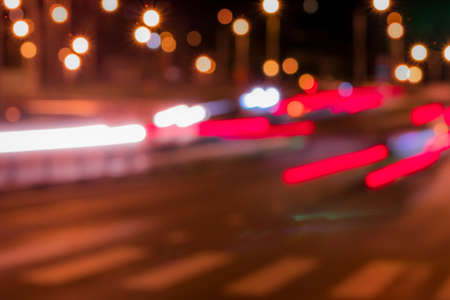 Traces of headlights from cars moving at night on the bridge, illuminated by lanterns. Abstract...