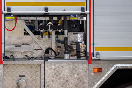 Rescue equipment of a fire engine with inscriptions in Russian. Pumps and hoses .
