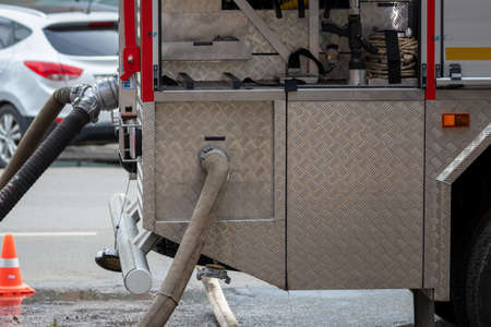 Fire engine rescue equipment. Pumps and hoses supplying water.