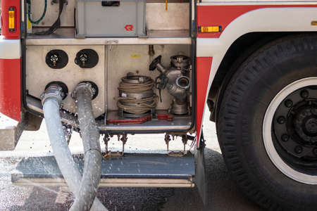 Fire engine rescue equipment. Pumps and hoses supplying water.の写真素材