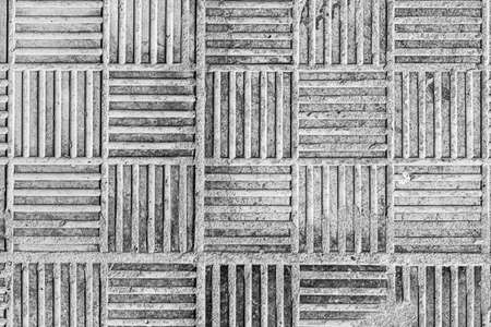 Top view on paving stone road. Old pavement of concrete texture. Street cobblestone sidewalk. Black...