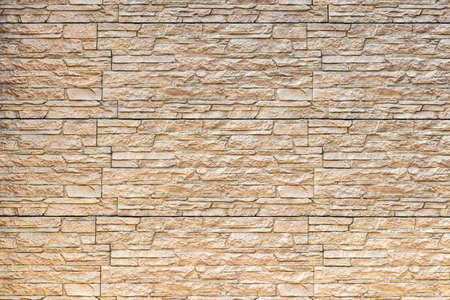 Monochrome texture of a wall covered with decorative brick-like tiles. Abstract background for...