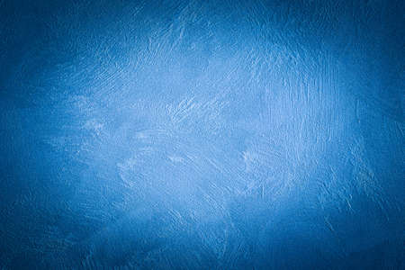 Blue decorative plaster texture with vignette. Abstract grunge background with copy space for...