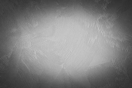 Gray decorative plaster texture with vignette. Abstract grunge background with copy space for design.の写真素材