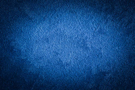 Blue decorative plaster texture with vignette. Abstract grunge background with copy space for...