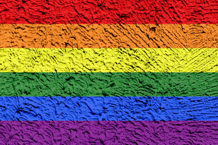 Rainbow LGBTQ or gay pride flag on decorative plaster or concrete texture. Abstract background for...