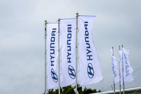 Russia, Kaluga - SEPTEMBER 29, 2020: White flags with Hyundai logos waving in the wind near a...