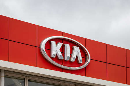 Russia, Kaluga - SEPTEMBER 29, 2020: Metallic Kia Motors logo on a red roof of a dealership.のeditorial素材