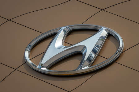 Russia, Kaluga - SEPTEMBER 29, 2020: Metallic Hyundai logo on a brown roof of a dealership.