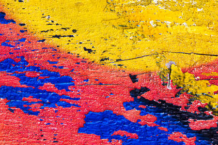 A fragment of colorful graffiti painted on a wooden board with peeling paint close-up. Abstract background for design.の写真素材