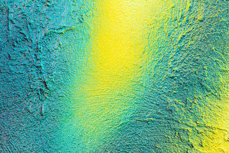 A fragment of colorful graffiti painted on a concrete wall. Abstract urban background for design.