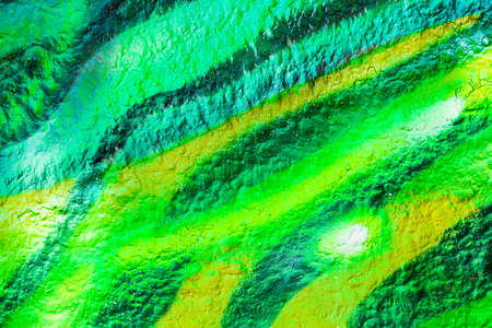 A fragment of colorful graffiti painted on a concrete wall. Abstract urban background for design.