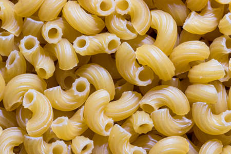 Top view of Italian uncooked chifferi pasta. Food texture.