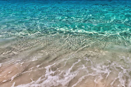 Sea surf on the beach with coral sand in the tropics. Close-up.の写真素材
