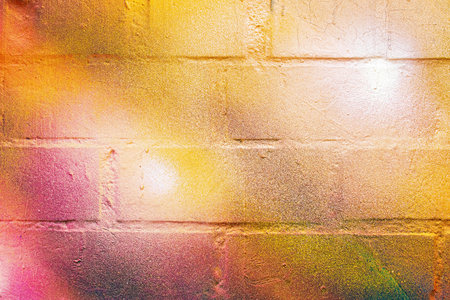 A fragment of colorful graffiti painted on a wall. Abstract urban background for design.