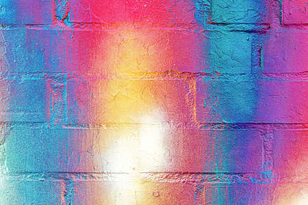 A fragment of colorful graffiti painted on a wall. Abstract urban background for design.