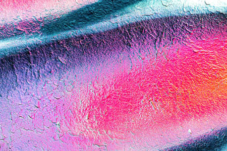 A fragment of colorful graffiti painted on a wall. Abstract urban background for design.