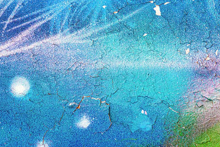 A fragment of colorful graffiti painted on a wall. Abstract urban background for design.の写真素材