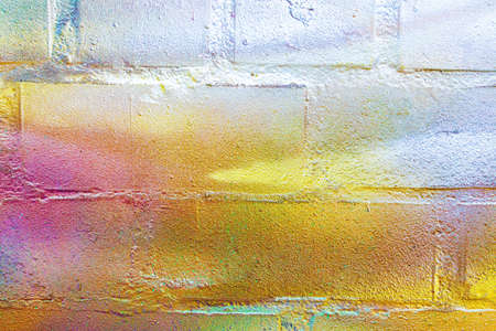 A fragment of colorful graffiti painted on a wall. Abstract urban background for design.