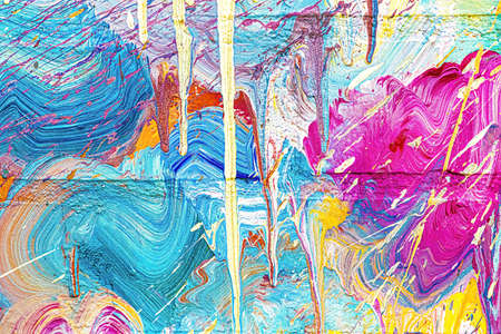 A fragment of colorful graffiti painted on a wall. Abstract urban background for design.