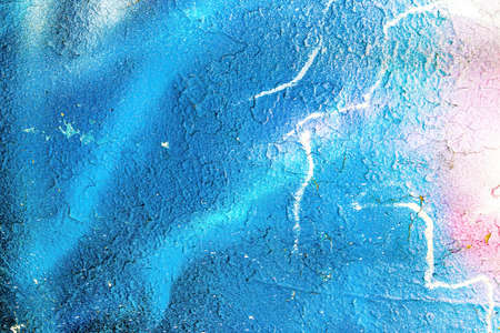 A fragment of colorful graffiti painted on a wall. Abstract urban background for design.