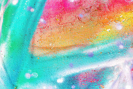 A fragment of colorful graffiti painted on a wall. Abstract urban background for design.