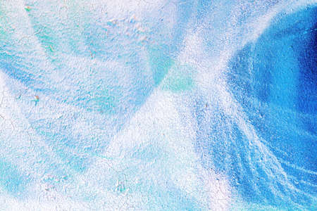 A fragment of colorful graffiti painted on a wall. Abstract urban background for design.