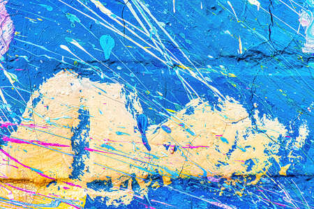 A fragment of colorful graffiti painted on a wall. Abstract urban background for design.
