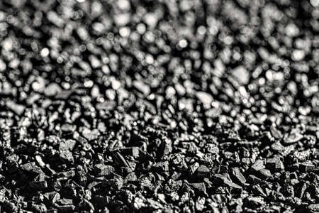 Close-up of black activated carbon texture. Coconut charcoal.