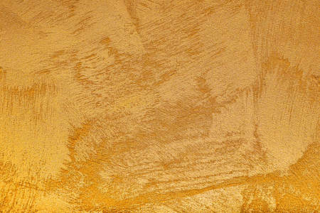 Texture of golden decorative plaster or concrete. Abstract grunge background for design.