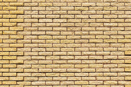 Yellow decorative brick wall texture. Abstract background for design.の写真素材