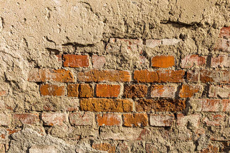 Wall texture from red old damaged bricks. Abstract background for design.